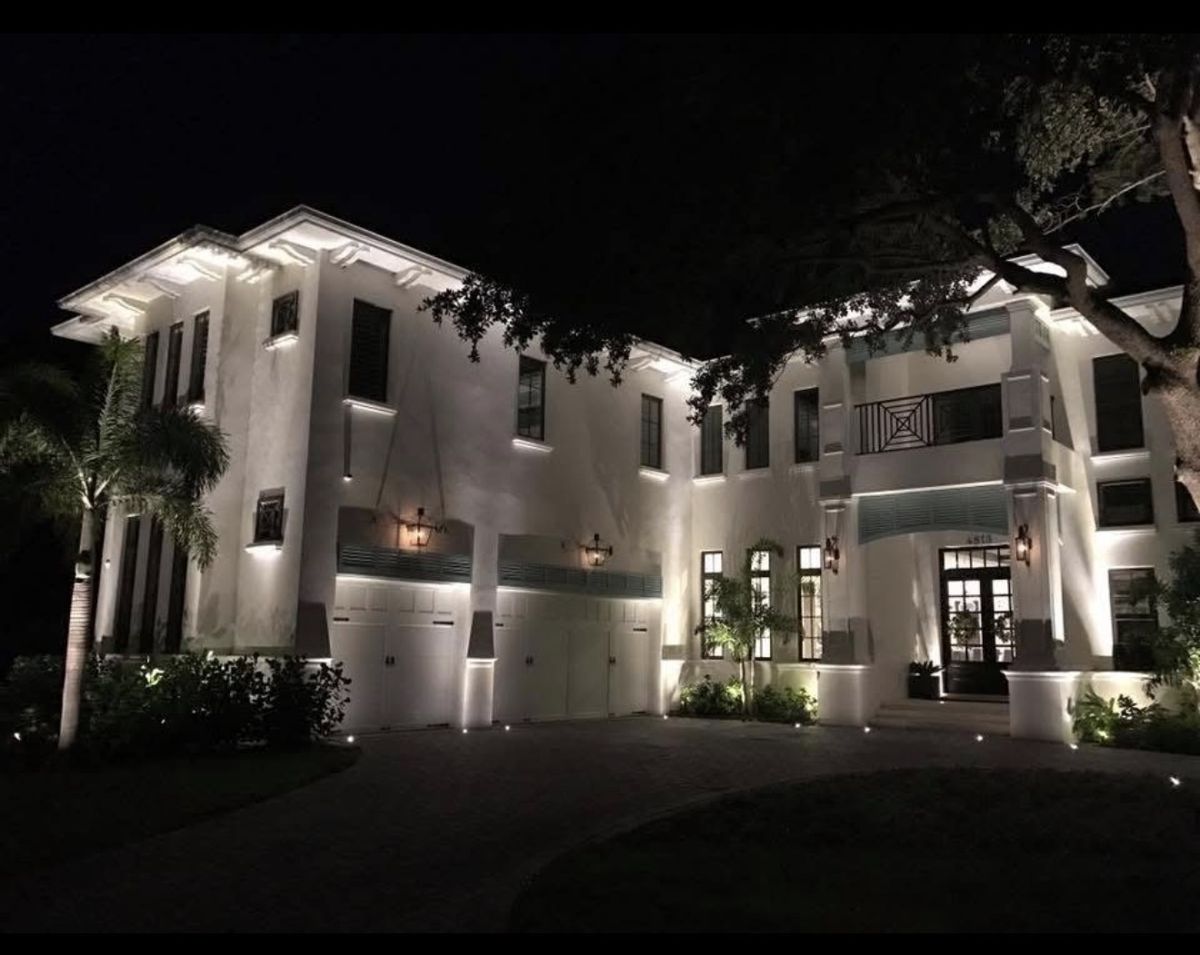 Culbreath Isles South Tampa modern two-story luxury estate with architectural LED uplighting at night — three-car garage and facade by LED Artistry