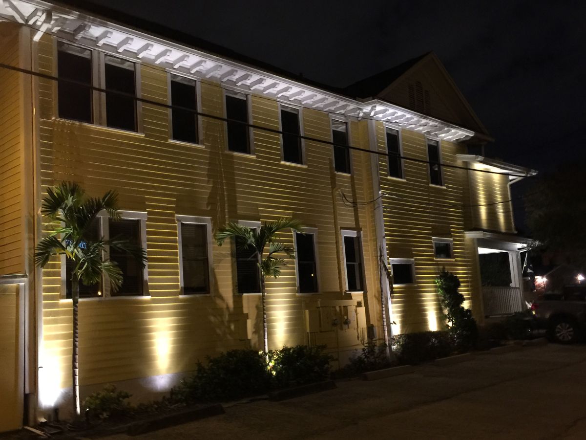 Barnes Trial Group law firm Tampa with warm white architectural LED uplighting and palm trees at night