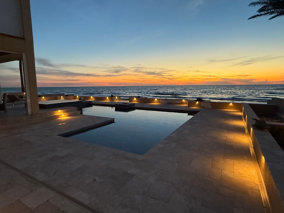 Swimming pool with embedded LED lighting at sunset